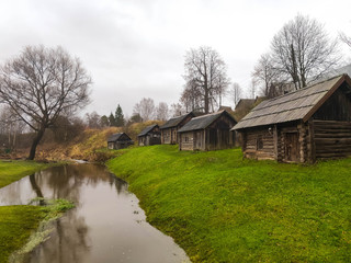 Fototapeta na wymiar Old wooden baths along a small river