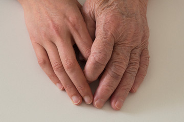 old and young hand together on the ground.