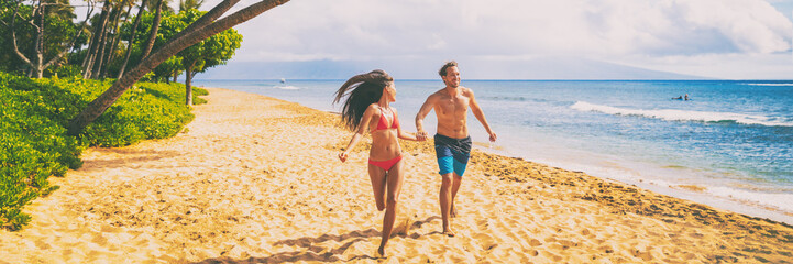Couple beach vacation banner walking happy travel vacation summer holiday panoramic. Young people...