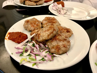 Turkish Meatballs Kofte / Kofta with Onions and Red Hot Chili Tomato Paste Sauce.