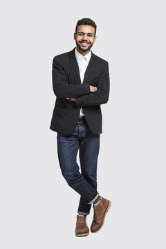 Full Length Studio Portrait Of Handsome Smiling Young Man Isolated On Gray Background	