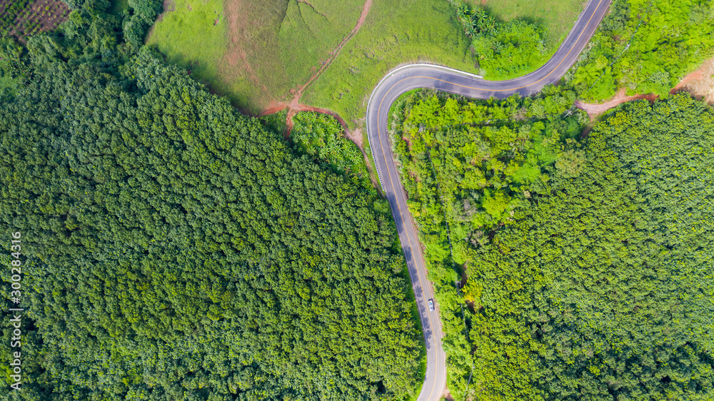 Wall mural Aerial view of Rural road in countryside area, view from drone