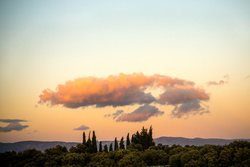 sunset with clouds over the trees