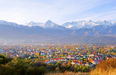 Panoramic view of the upper part of Almaty city on the background of mountains in autumn season; golden fall, beauty and greatness of Kazakhstan concept