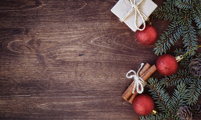 Obraz premium New Year's background. Spruce branches on a wooden table. Ornaments for the New Year tree. Christmas concept.