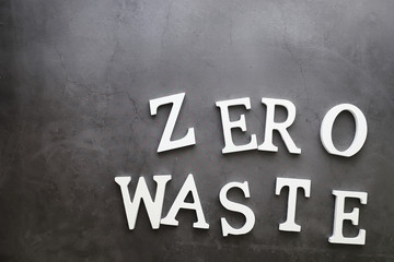 The concept of proper and environmental health. The inscription on black background with wooden letters and paper elements. Free GMO. Zero waste.