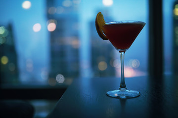 Cocktail glasses on the windowsill by the glass
