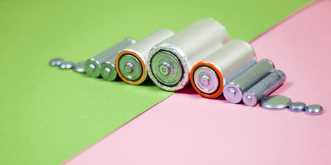 Many different types used or new battery, rechargeable accumulator, alkaline batteries on color...