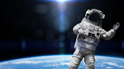 Naklejka premium astronaut in orbit of planet Earth