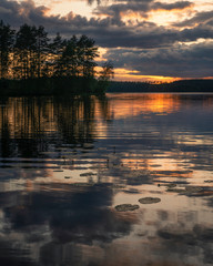 Midnight sun over summer lake in Finland