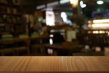 Empty dark wooden table in front of abstract blurred bokeh background of restaurant . can be used for display or montage your products.Mock up for space.