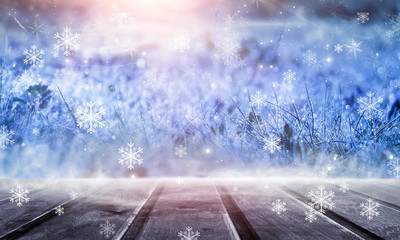 Winter wooden table. Forest winter landscape, snowflakes, sunlight.