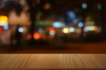 Empty dark wooden table in front of abstract blurred bokeh background of restaurant . can be used for display or montage your products.Mock up for space.