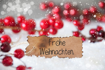 Fototapeta na wymiar Burnt Label With German Calligraphy Frohe Weihnachten Means Merry Christmas. Red Christmas Decoration With Snow And Snowflakes