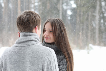 Fototapeta premium pair of lovers on a date winter afternoon in a snow blizzard