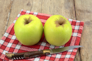 yellow apple on a wooden table