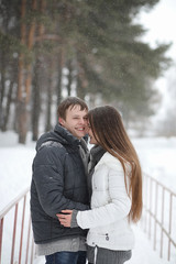 Fototapeta premium pair of lovers on a date winter afternoon in a snow blizzard
