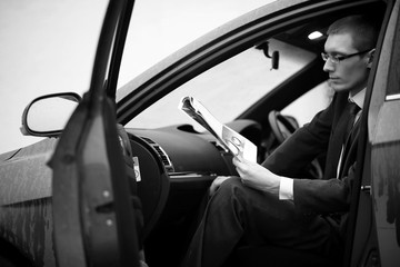 Fototapeta na wymiar Businessman in a suit in a car