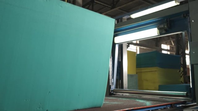 Large block of paralon, raw materials, production of mattresses, machine with saw, preparation for work, manual method of loading, industry, conveyor loading, business, manufacturing of mattresses