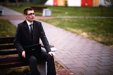 A man in a suit lies on a brick floor