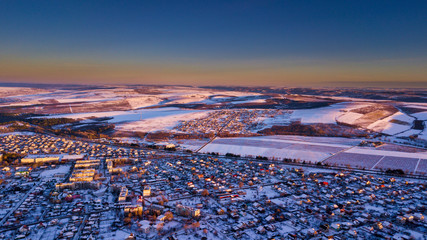 Top view of city suburbs or small town nice houses on winter sunset on cloudy sky background....