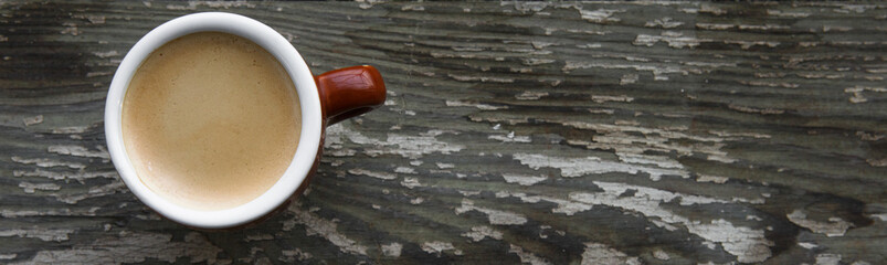 Cup of hot coffee on the wooden table