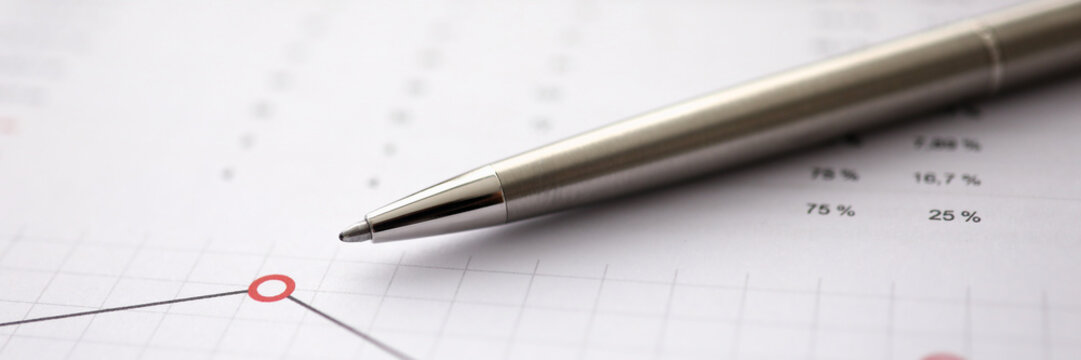 Business background chart with silver pen lie