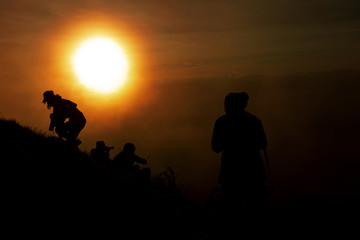 Fototapeta premium Shadow of women at the top of the mountain During sunset