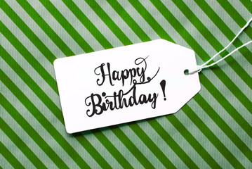 Label With English Calligraphy Happy Birthday. Green Wrapping Paper As Background