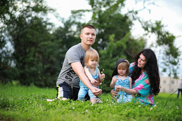 Obraz premium Mom with two daughters twins