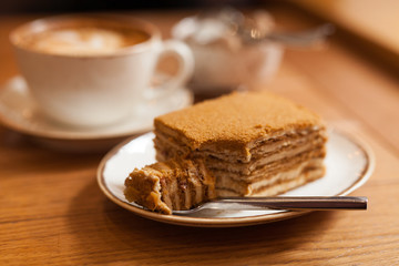 Honey cake on wood table, close-up