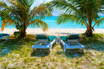 Lounge chairs on a beautiful tropical beach at Maldives