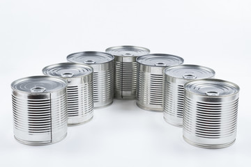 Group of silver canned food on white background.