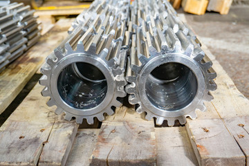 Gears on the rack after manufacturing at the manufacturing plant. Gear cutting in mechanical...