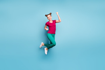 Fototapeta na wymiar Full length body size turned photo of excited ecstatic rejoicing girl wearing red t-shirt green pants trousers screaming yeah in sneakers isolated over blue pastel color background