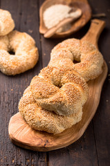 Greek koulouri or Turkish bagels called Simit in stack. Traditional street food, crispy sesame bread ring bagels