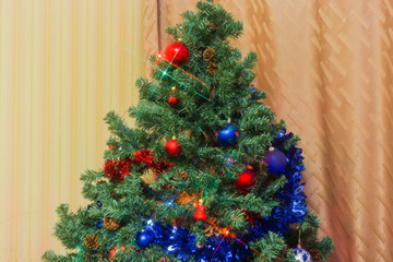 Fragment of artificial Christmas tree with decoration and Christmas lights