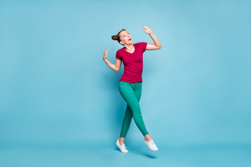 Fototapeta premium Full length body size photo of cheerful positive cute nice charming attractive girlfriend wearing green pants trousers white footwear dancing stepping isolated pastel color background