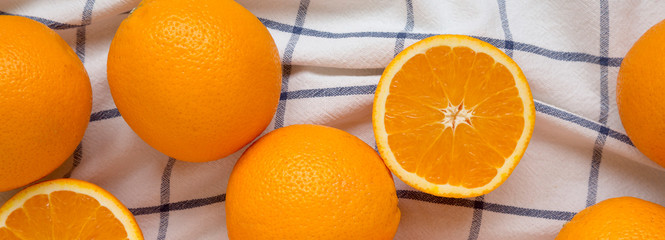 Fresh ripe organic oranges on cloth, overhead view. Flat lay, top view, from above. Close-up.