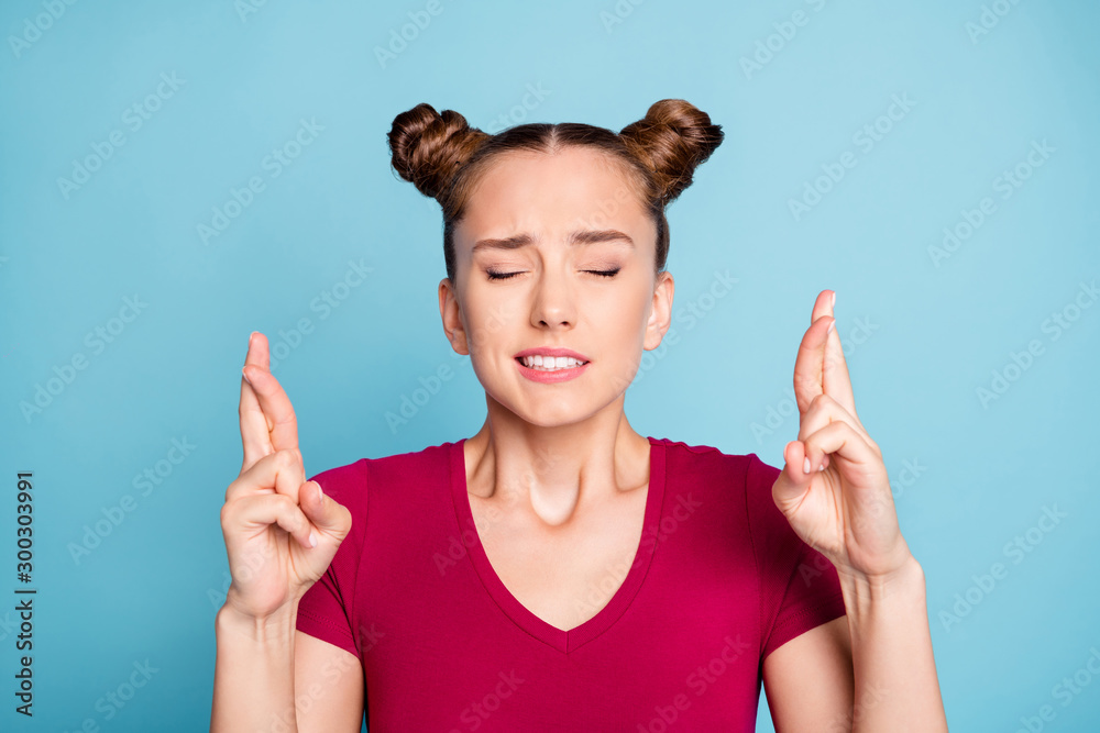 Canvas Prints Close up photo of worried troubled stressed girl with fingers crossed expecting terrible results of her exam with eyes shut closed wearing red t-shirt isolated over blue pastel color background