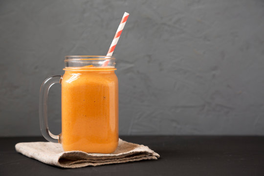 Homemade Pumpkin Smoothie In A Glass Jar Mug, Side View. Copy Space.