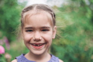 Adorable 6-7 years old girl with toothless smile