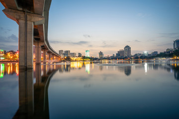 Hanoi cityscape at twilight at Hoang Cau lake, with the Cat Linh-Ha Dong elevated railroad