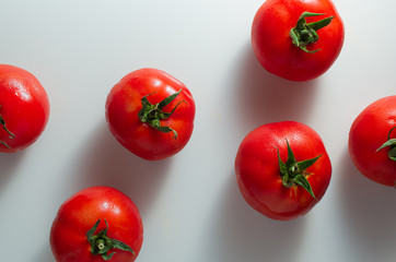 Red tomatoes isolated over white background. Fresh vegetables. Vegan. Healthy food.