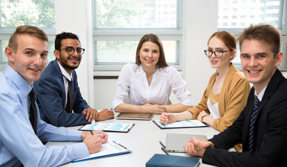 Fototapeta premium International business team smiling looking at camera