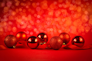 Christmas balls with ribbon on abstract light background. Christmas background with decorations