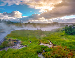 Iceland. Steam rises above the hot pots. Thermal springs. Renewable energy.