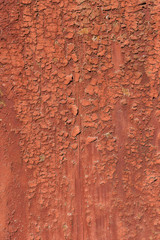 Old and peeling paint Over time, the red paint peeled off from the old boards and the wood texture cracked. Vintage Abstract Grunge Background