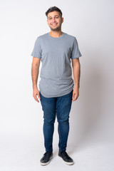 Fototapeta premium Full body shot of happy young Persian man smiling