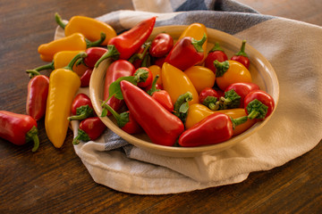 food background. soft focus of red and yellow chili peppers in ceramic bowl